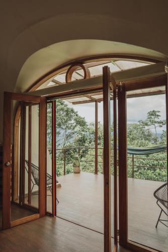 an open door to a room with a balcony at Vibra Healing Lodge y Spa in Teniente Hugo Ortiz
