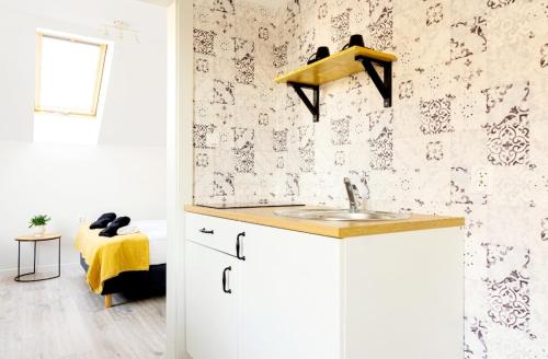 a bathroom with a sink and a wall at Przy Plaży in Karwia