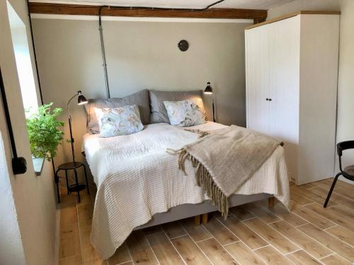 a bedroom with a bed with a white comforter at Nygård Apartments in Klagstorp