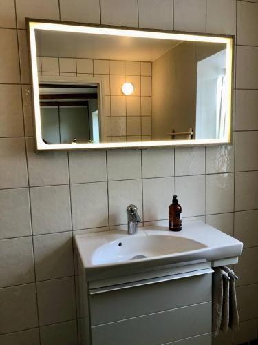a bathroom with a sink and a mirror at Nygård Apartments in Klagstorp