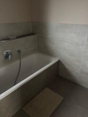 a bathroom with a bath tub with a sink at 2 Zimmer Ferienwohnung-Neubau zu vermieten in Memmingen