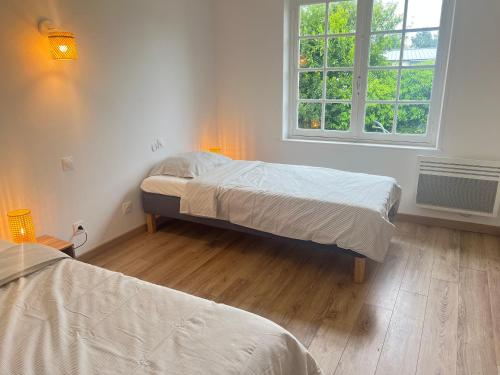 メルリモン・プラージュにあるLes Sylphides - Villa de charme à Merlimont-Plage - 4 personnesのベッド2台と窓のある寝室