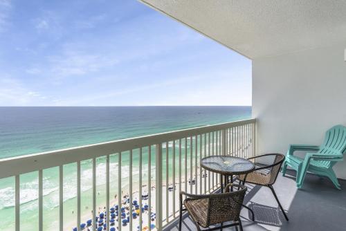 a balcony with a table and chairs and the ocean at Pelican Beach Resort Top 20th Floor Condos with Ocean View in Destin