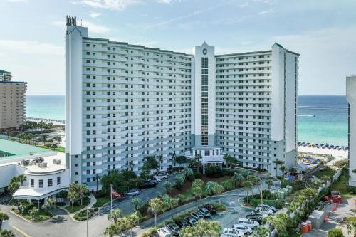 a large white building next to the ocean at Pelican Beach Resort Top 20th Floor Condos with Ocean View in Destin