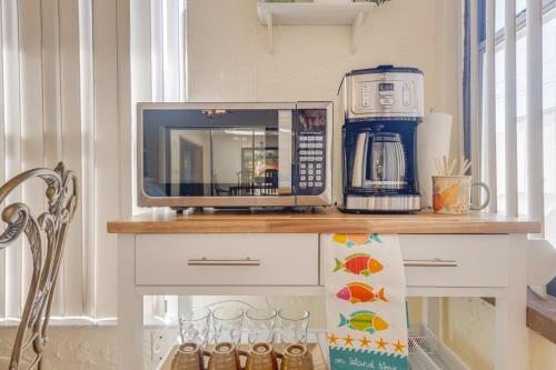 a counter with a microwave and a coffee maker on it at Private Entry-King & Queen rooms in Clearwater