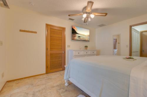 a bedroom with a bed and a ceiling fan at Private Entry-King & Queen rooms in Clearwater