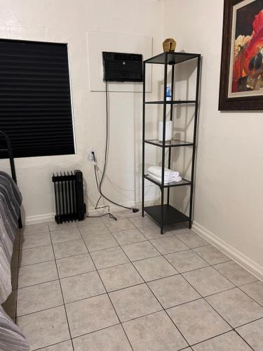 a room with a tiled floor with a book shelf at Downtown Purple Apartment in Phoenix