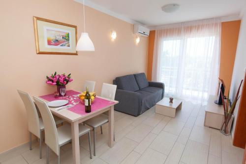 a living room with a table and a couch at Apartments Ines in Selce