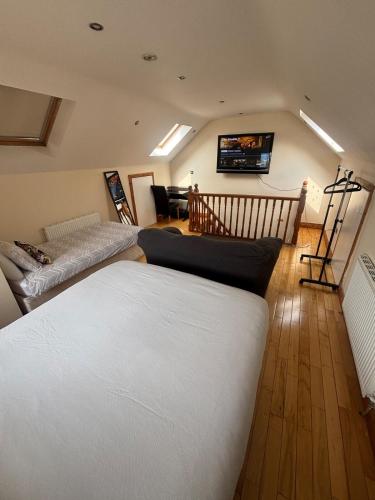 a living room with a bed and a couch at Luxury Home in Dublin WiFi TV B&B Close to City Centre in Lucan