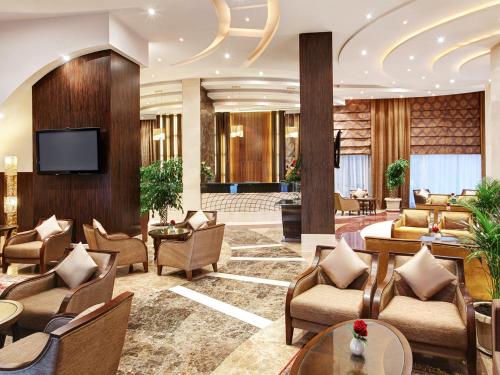 a lobby of a hotel with couches and chairs at Elaf Kinda Hotel in Makkah