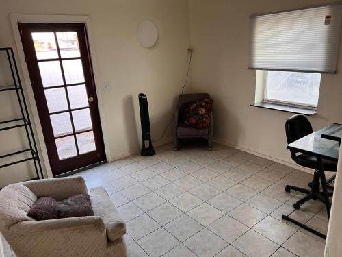 a living room with a couch and a chair at Downtown Purple Apartment in Phoenix