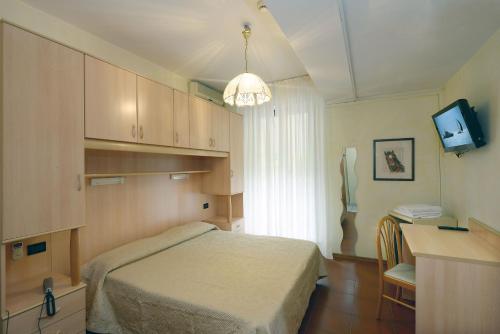 Кровать или кровати в номере Hotel Ristorante Commercio