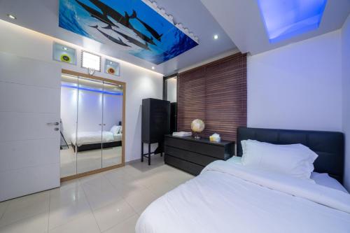 a bedroom with a large bed and a bathroom at Luxury Three bedroom Apt Al Yasmin in Riyadh