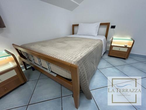 a bedroom with a bed and two night stands at La Terrazza in Castellammare di Stabia