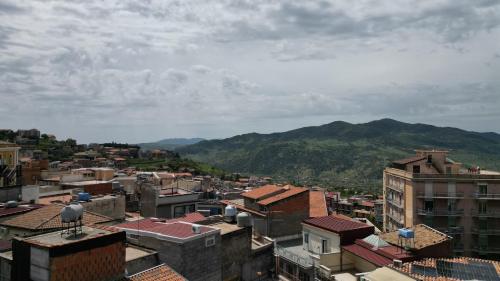 a view of a city with mountains in the background at SVR Palace in Bronte