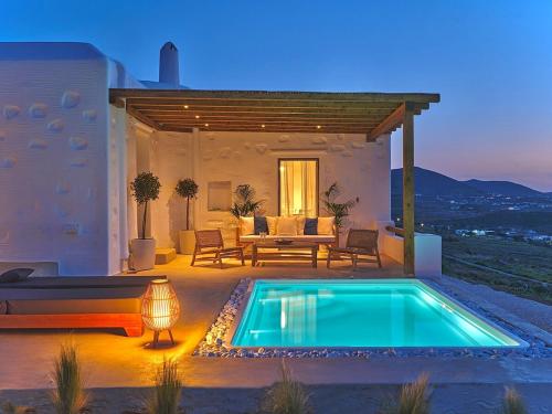a backyard with a swimming pool and a patio at Aetheron Villa, Naousa in Naousa