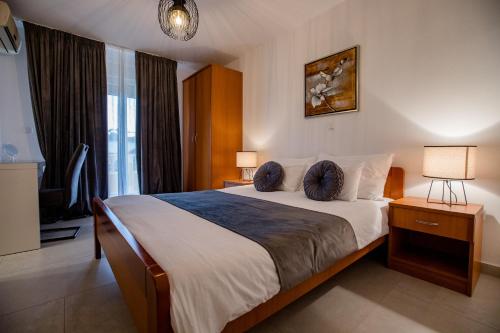 a bedroom with a bed with two pillows on it at Apartmani Mery in Rab