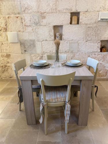 a wooden table with chairs and a table and a table and chairsktop at Civico 39 in Ostuni