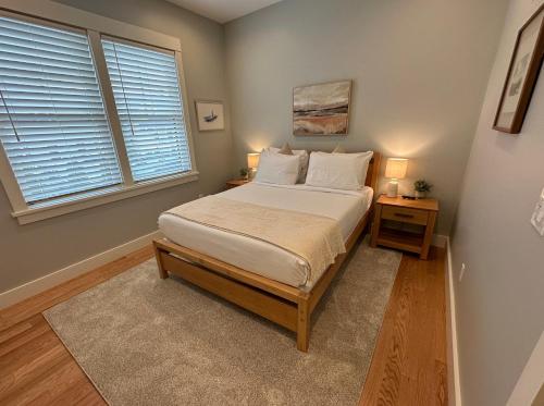a bedroom with a bed with two night stands and a window at Brand New Construction! 3 Unit5 Bed Property in Newport