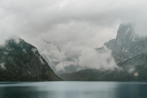 a view of a lake with mountains in the background at Strandcafé Hideaways Altaussee in Altaussee