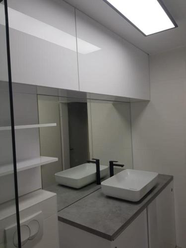 a bathroom with a sink and a mirror at Apartmani Mery in Rab