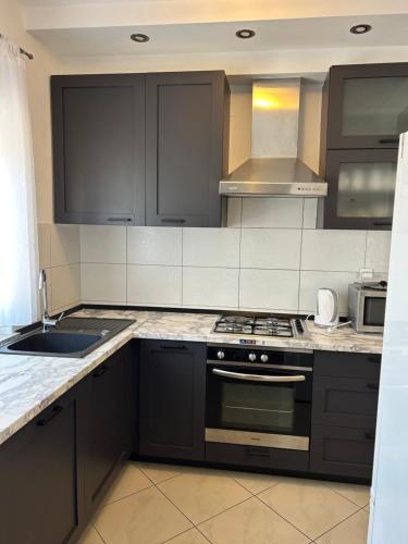 a kitchen with a stove and a sink at Apartments Purkovic in Vodice