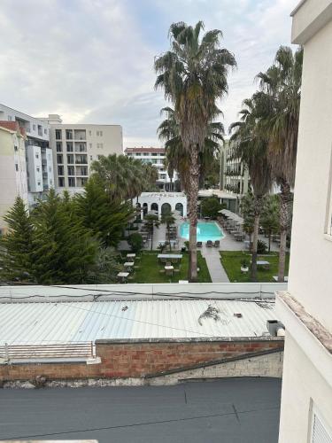 a view of a pool and palm trees from a building at Ambla holidays in Golem
