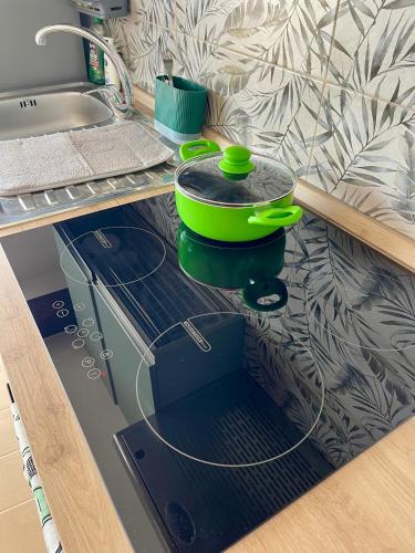 a kitchen counter with a stove with a pot and pans at Loft Al Baglio del Gelso in Balestrate