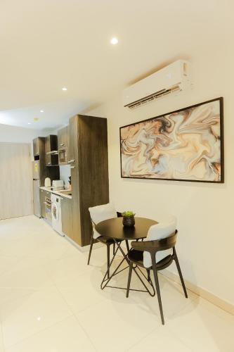 a kitchen with a table and chairs and a painting on the wall at Accra Luxury Apartments @ The Lennox in Accra