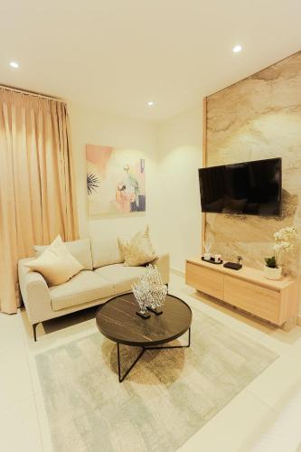 a living room with a couch and a coffee table at Accra Luxury Apartments @ The Lennox in Accra