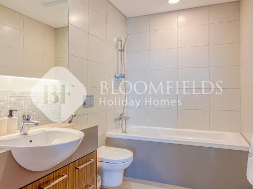 Un baño con lavabo, inodoro y bañera. en Bloomfields Grandeur 1BR In Lamar Raha, en Abu Dabi