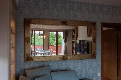 a mirror on the wall of a living room at Palic Memories by Vermes - Lake View in Palić