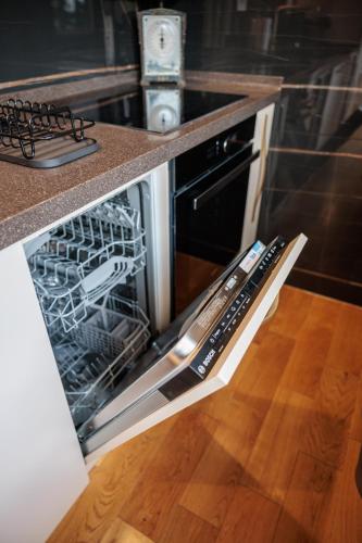 an oven with the door open in a kitchen at Palic Memories by Vermes - Lake View in Palić