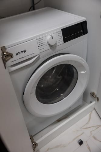 a white washing machine sitting in a bathroom at Palic Memories by Vermes - Lake View in Palić