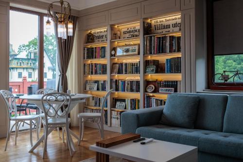 a living room with a book shelf filled with books at Palic Memories by Vermes - Lake View in Palić