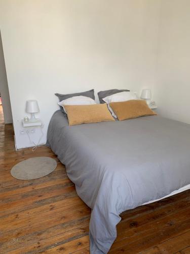 - un lit blanc avec des oreillers dans la chambre dans l'établissement Appartement ville mer, à Brest