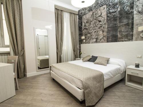 a hotel room with a bed and a mirror at Velvet Suite in Rome