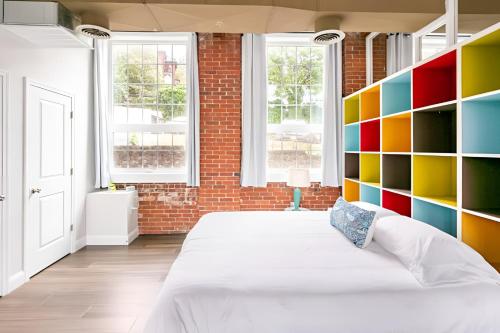a bedroom with a large bed with a colorful wall at Jennifer's Historic Loft Glass Bedroom in Providence