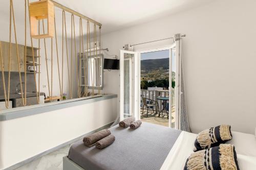 a bedroom with a bed with two teddy bears on it at Santanna White Houses in Parikia