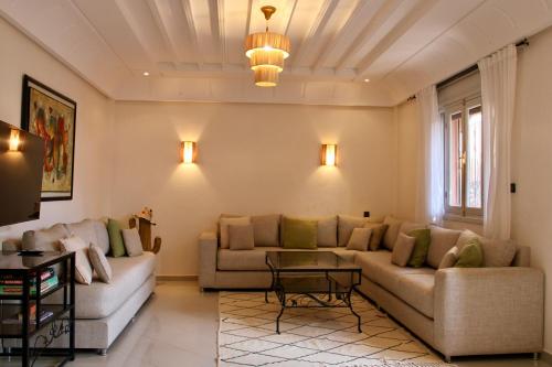 a living room with a couch and a table at Seaside 2 Bedrooms Villa - IMI OUADDAR in Agadir