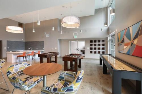 a large room with ping pong tables and chairs at Cozy 2BR Apt in Downtown LA with Pool & Hot Tub in Los Angeles