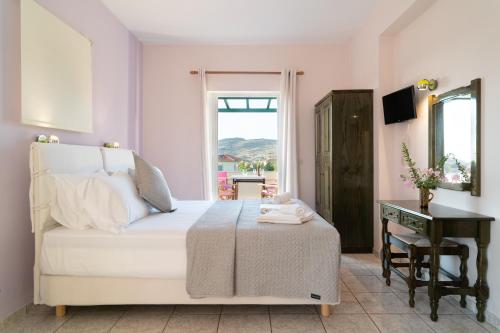 a bedroom with a bed and a table and a window at Vasiliki Studios in Petra