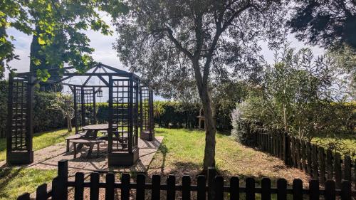 a park with a picnic table and a tree at Podere Isabella in San Vincenzo