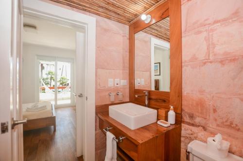a bathroom with a sink and a mirror at STANZA MARE 1 Br,2Br,3Br APARTAMENT ON THE BEACH in Punta Cana