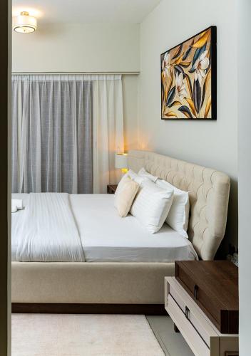 a bedroom with a large bed with white pillows at 2BR Apartment In Dubai in JVC near Circle mall in Dubai