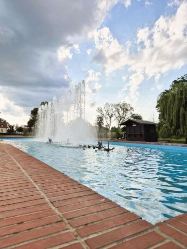 a large swimming pool with a water fountain at Gajeva Rooms - Toronto apartment SELF CHECK-IN in Virovitica