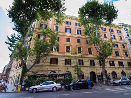a large building with cars parked in front of it at Velvet Suite in Rome