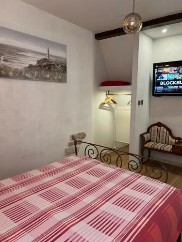 a bedroom with a bed and a tv on the wall at Apartment Nikolina in Trogir