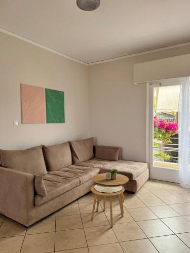a living room with a couch and a table at Olive House in Khalkoútsion