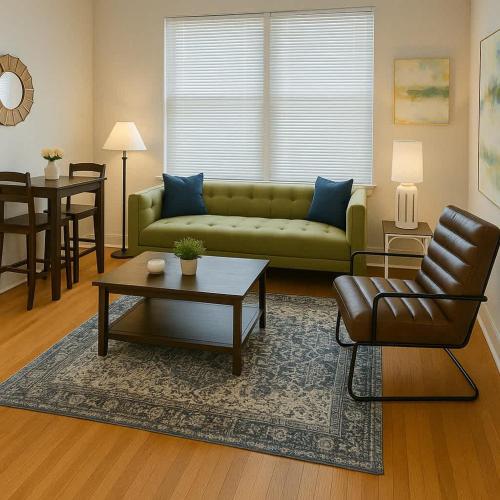 a living room with a green couch and a table at 1BR Fully Equipped & Central - Belmont rep in Chicago